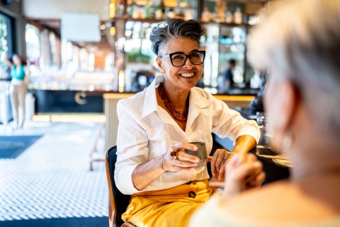 Businesswoman chatting and drinking tea while celebrating a public holiday in Burundi