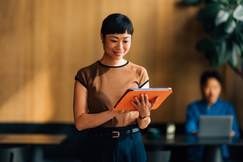 Businesswoman going through her M&A due diligence checklist