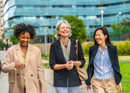 Businesswomen in Finland walking and talking outside in an urban park