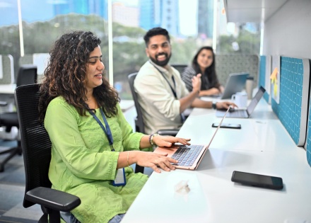 Colleagues discussing Indian work culture at the office