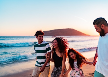 Family walking on a beach, enjoying Trinidad and Tobago’s public holidays