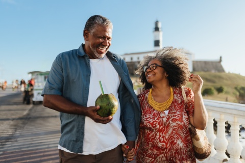 Happy senior couple enjoying a beach walk during a Dominican Republic public holiday
