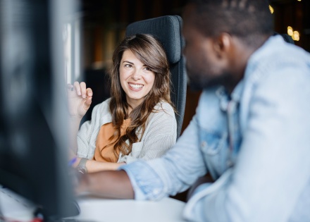 Focus on woman talking with blurred man on how to get a work visa in Angola