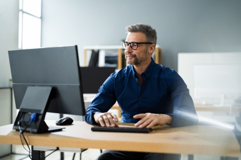 Male accountant using business computer in office