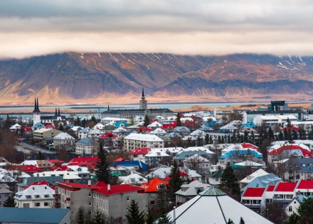 The rooftops of Reykjavik in Iceland with mountains in the background