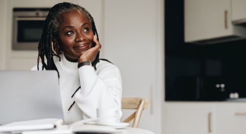 Senior businesswoman in her home office doing payroll taxes in French Guiana