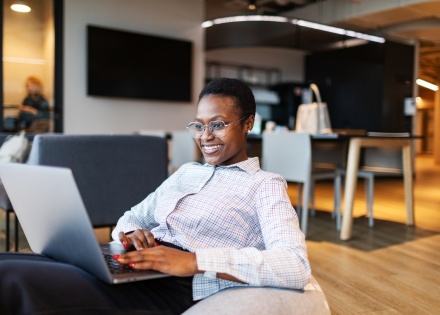 Young businesswoman using her laptop in a modern coworking space