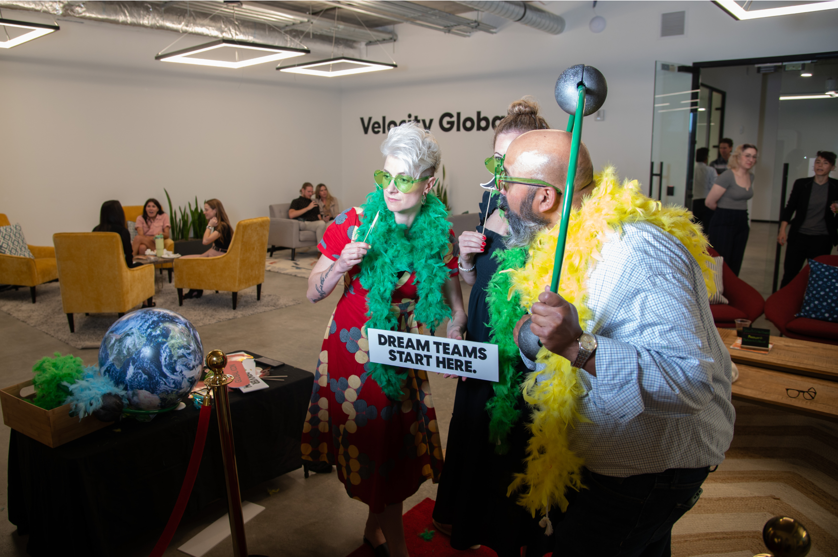 Pebl team members pose for a photo at a photo booth.