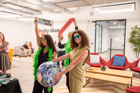 Pebl team members pose with photo booth props.